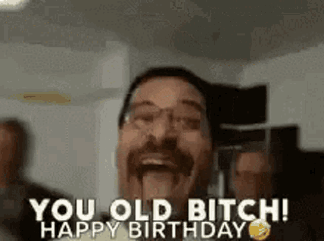 a man with glasses is making a funny face and saying `` you old bitch happy birthday '' .