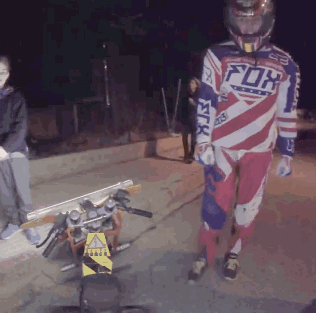 a man wearing a red white and blue fox racing jersey