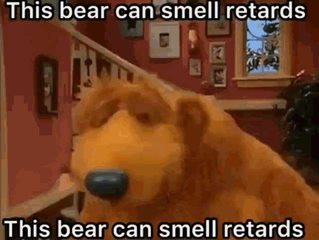 a stuffed bear is sitting on a staircase in a room with a caption that says this bear can smell retards .