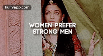 a woman is peeking out from behind a wall with the words `` women prefer strong men '' .