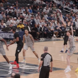 a basketball game is being played in front of a crowd and the number 22 is on the jersey of the player
