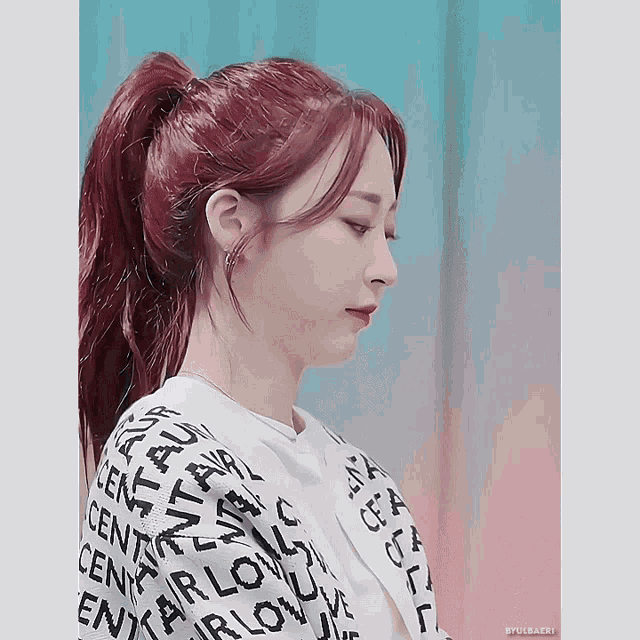 a woman with red hair is wearing a sweater that says centerlove on it