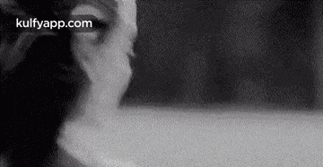a black and white photo of a woman 's face .