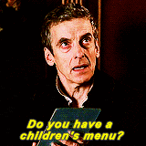 a man is holding a piece of paper and asking if he has a children 's menu