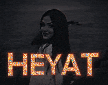 the word heyat is lit up with sprinkles on a black background