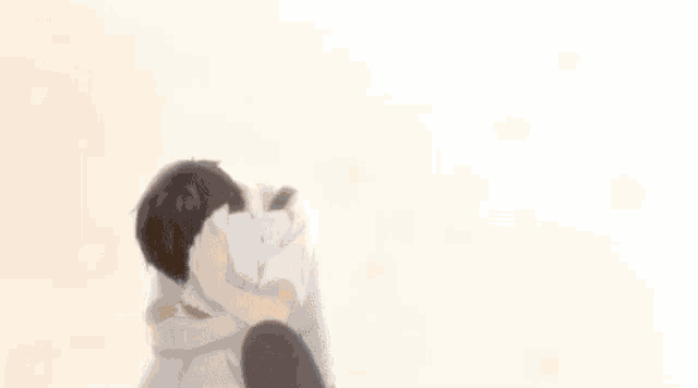 a man wearing glasses is petting a white cat