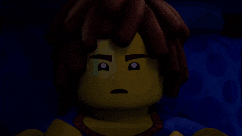 a close up of a lego character with a tear in his eye