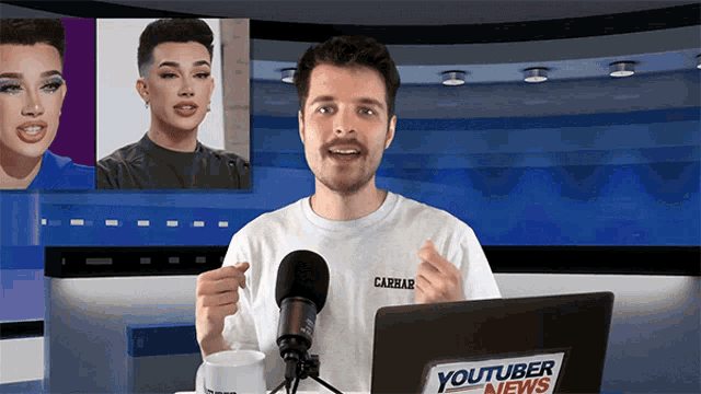a man stands in front of a laptop with a youtuber news logo on it