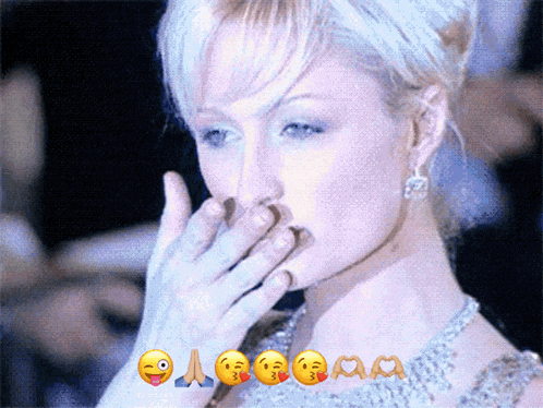 a woman is covering her mouth with her hand and emojis are surrounding her