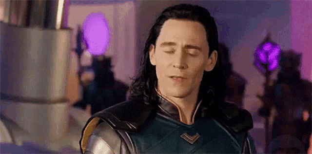 loki from avengers : age of ultron is looking down with his eyes closed .