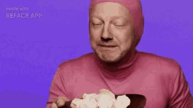 a man in a pink bodysuit is making a funny face on a purple background .