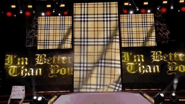a sign that says i 'm better than you is on a stage