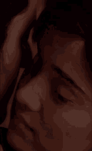 a close up of a man and woman 's faces with their eyes closed