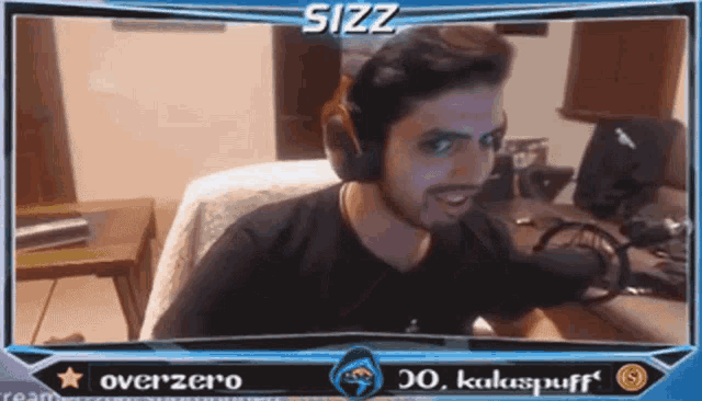 a man wearing headphones is sitting in front of a screen that says sizz overzero and kukuspuff