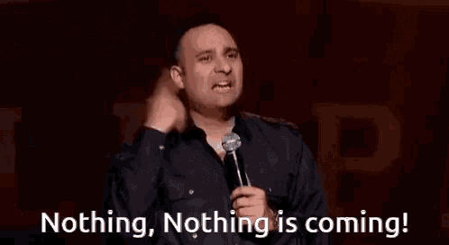 a man is holding a microphone and saying nothing , nothing is coming !
