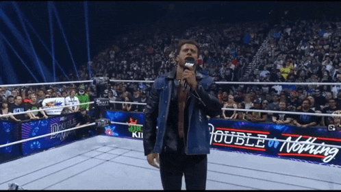 a man singing into a microphone in front of a crowd with the words hate hate hate