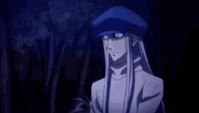 a man with long hair and a blue hat is standing in the dark .