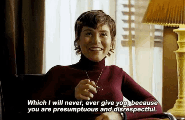 a woman is sitting in a chair holding a key and smiling .