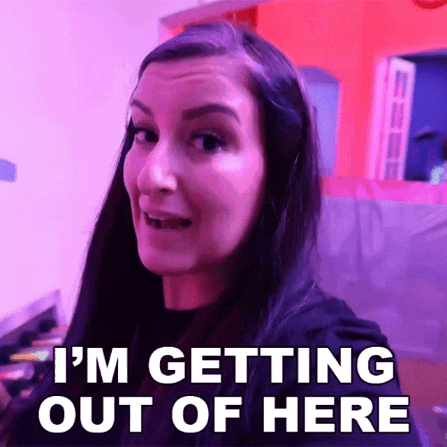 a woman says i 'm getting out of here in front of a pink background