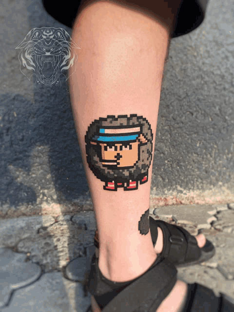 a pixel art tattoo of a sheep with a blue hat
