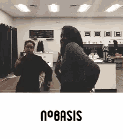 two women are dancing in a room with the word basis on the bottom right