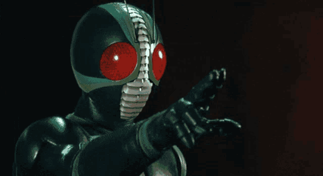 a masked superhero is pointing at something