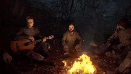 a group of people are sitting around a campfire in the woods .