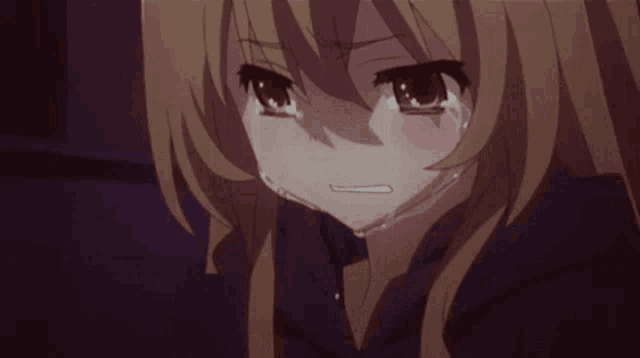 a close up of a girl crying with her eyes closed