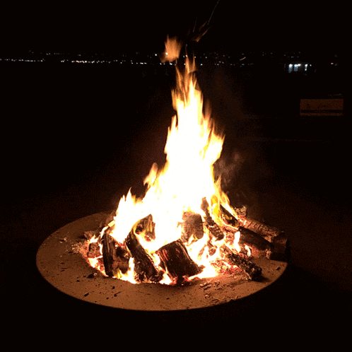 a fire is burning in a concrete fire pit