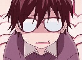 a close up of a boy wearing glasses and a purple shirt .