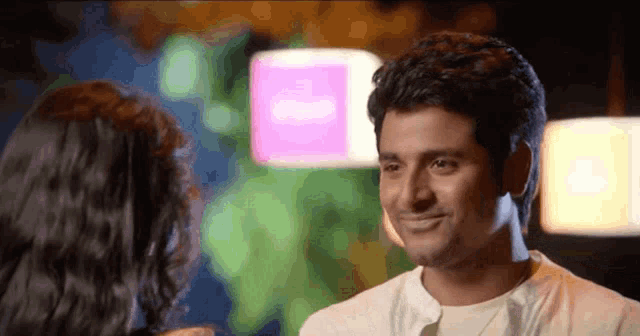 a man and a woman are smiling at each other
