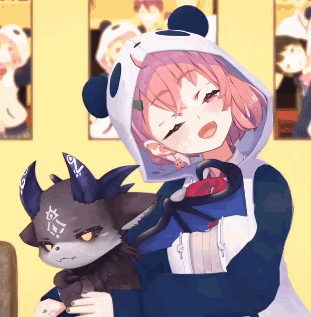 a girl in a panda hoodie holds a stuffed animal with horns