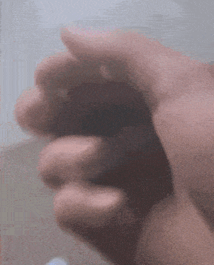 a close up of a person 's hand with a blurred background