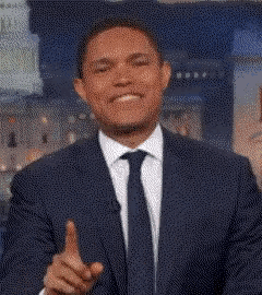 a man in a suit and tie is pointing his finger