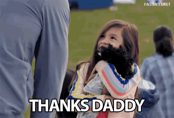 a little girl is holding a stuffed animal and saying `` thanks daddy '' .