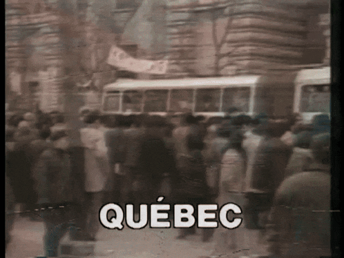 a blurry picture of a crowd of people with the word quebec in the upper left corner