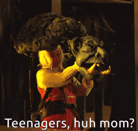 a woman in a red dress is holding a monster head with the words teenagers huh mom written on the bottom