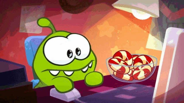 a cartoon character sitting at a desk with a bowl of candy