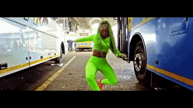 a woman with green hair is dancing in front of a bus that says lk