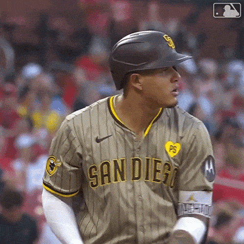 a baseball player wearing a san diego jersey is standing on the field