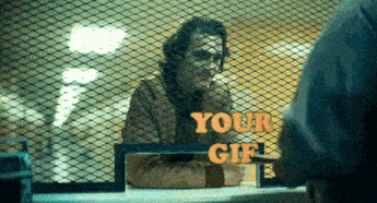 a man is behind a fence with a sign that says " your gif "