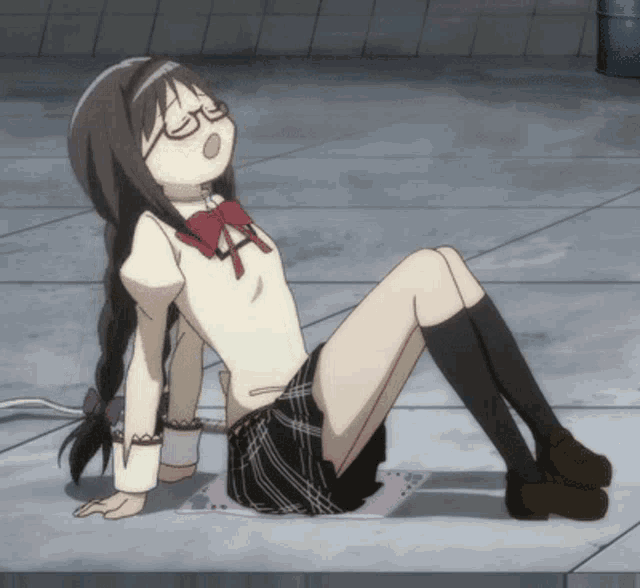 a girl with glasses is sitting on the ground