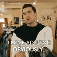 a man is standing in a store holding a jacket and saying `` i love you too obviously '' .