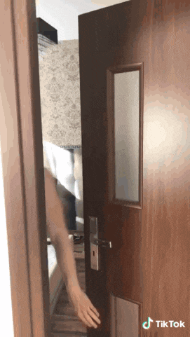 a tiktok video of a person opening a door with a mirror