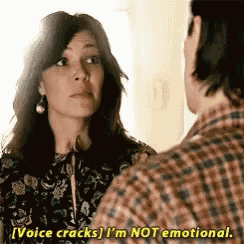 a woman is talking to a man in a plaid shirt and says voice cracks i 'm not emotional .