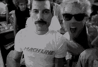 a man with a mustache wearing a machine shirt