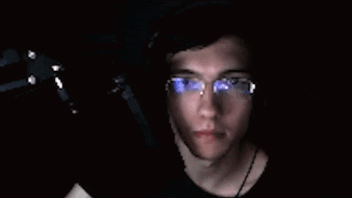 a blurry picture of a man with glasses and headphones