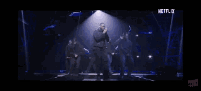 a group of people are dancing on a stage with a netflix logo in the corner