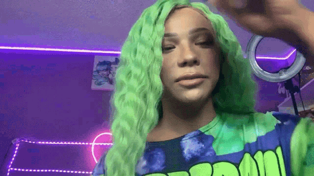a person with green hair is wearing a shirt that says " boom "