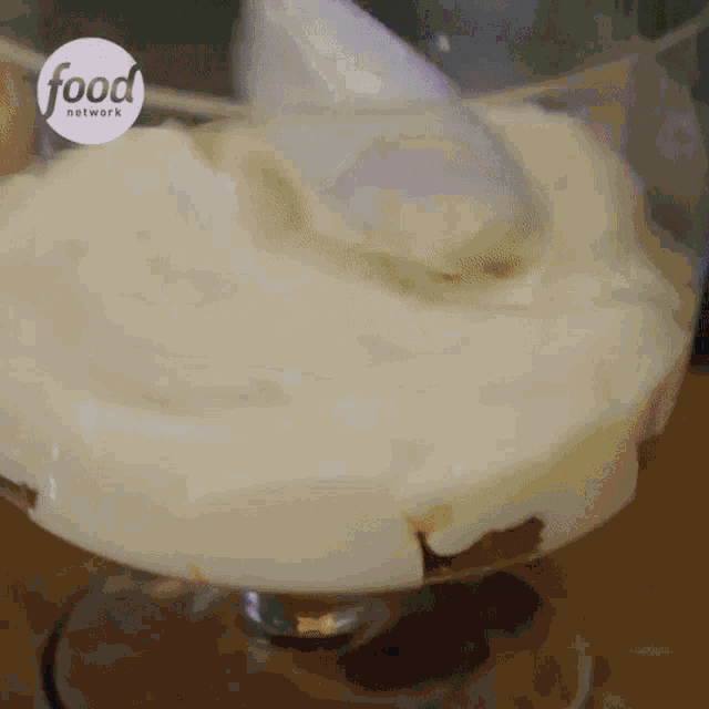 a glass of food with a spoon in it
